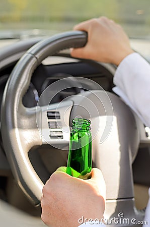 Woman drinking while driving Stock Photo