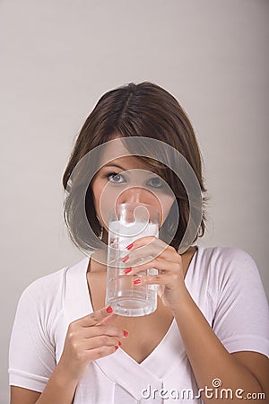 Woman drinking a glass of ice water Stock Photo