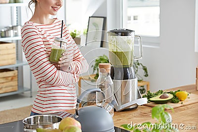 Woman drinking green shake Stock Photo