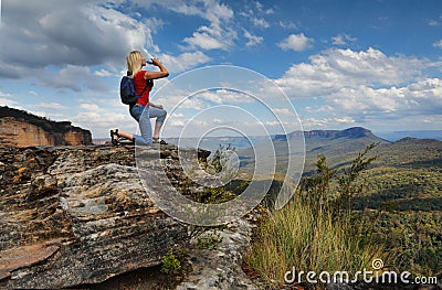 Woman drinking water on mountain summit Australia Stock Photo