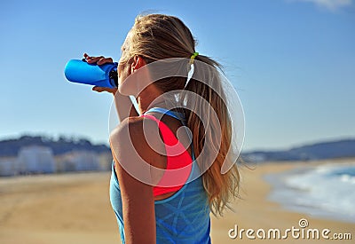 Woman drinking water after running Stock Photo