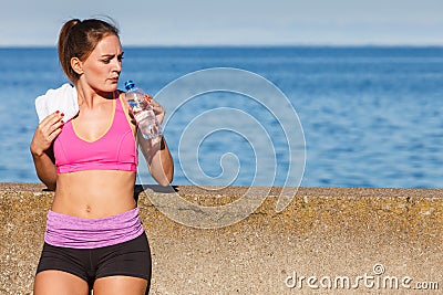 Woman drinking water after sport gym outdoor Stock Photo