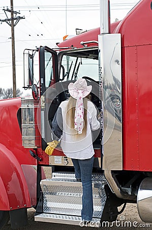 Woman driver entering the cab Stock Photo