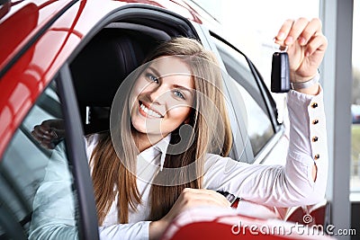 Woman Driver Holding Car Keys siting in New Car Stock Photo