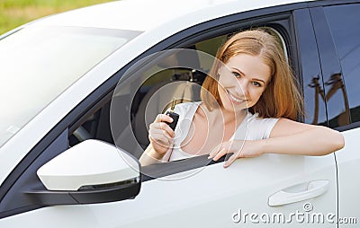 Woman driver with keys driving a new car Stock Photo