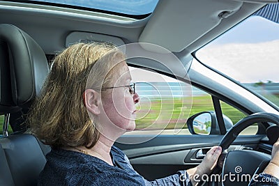 Woman drives the car concentrated on a german highway Stock Photo