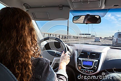 Woman driving car on highway, inside view Stock Photo