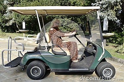 Woman driving golf carts Stock Photo