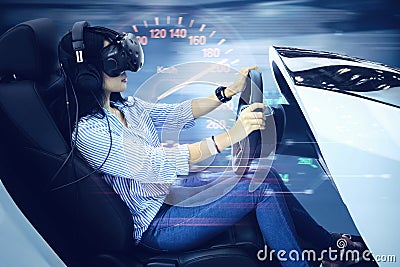 Woman driving a simulator car with fast motion Stock Photo