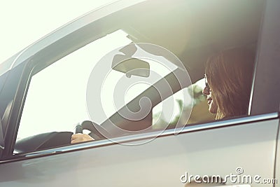 Woman driving in a sunny day Stock Photo