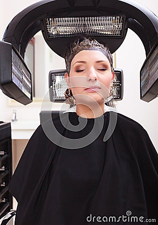 Woman dying hair in hairdressing beauty salon. Hairstyle. Stock Photo