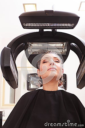Woman dying hair in hairdressing beauty salon. Hairstyle. Stock Photo