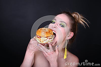 Woman eating big hamburger Stock Photo