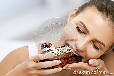 Woman Eating Cake. Beautiful Female Eating Dessert Stock Photo