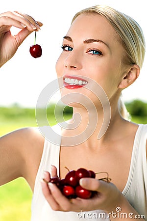 Woman eating cherries Stock Photo