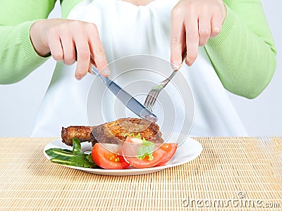 Woman eating chicken Stock Photo