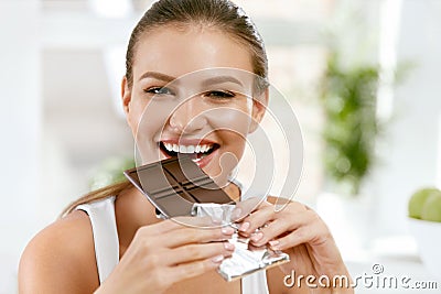 Woman Eating Chocolate. Beautiful Girl With Sweets. Stock Photo