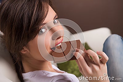 Woman eating chocolate. Stock Photo