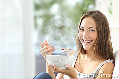 Woman eating cornflakes at home Stock Photo