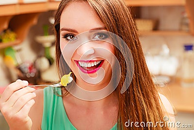 Woman eating cream cake with fruits. Gluttony. Stock Photo