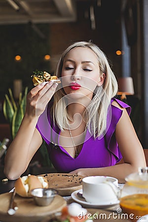Woman eating danish smorrebrod in restaurant Stock Photo