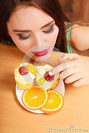 Woman eating delicious sweet cake. Gluttony. Stock Photo
