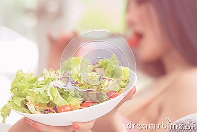 Woman eating green healthy Vegetable salad and relaxing at home for woman beauty and healthy lifestyle eating. Woma realxing Stock Photo