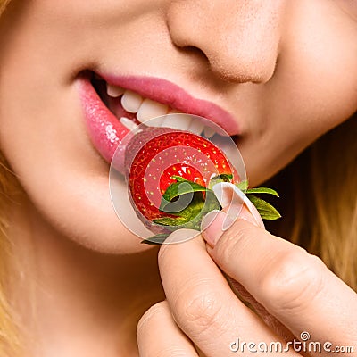 Woman eating mellow strawberry Stock Photo