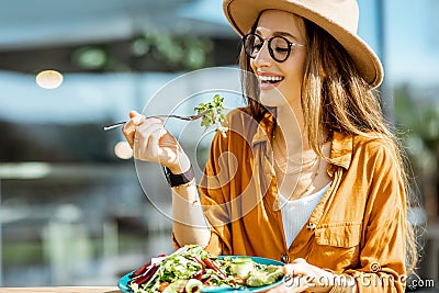 Woman eating salad on a cafe terrace Stock Photo