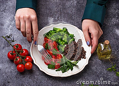 Woman eating vegan salad Stock Photo