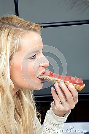 Woman eating a wholewheat roll Stock Photo