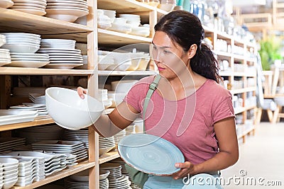 Woman electing plates in store Stock Photo