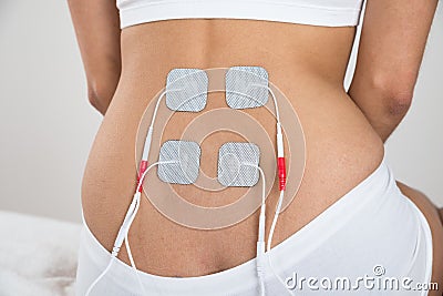 Woman with electrodes on her back Stock Photo