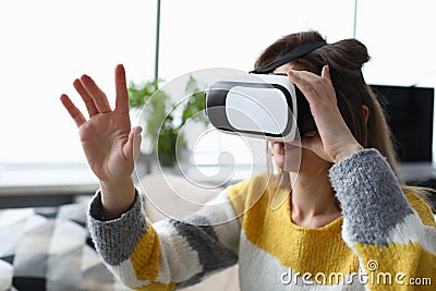 Woman in electronic professional virtual reality glasses watch simulator video. Stock Photo