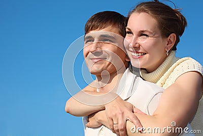 Woman embraces man from behind Stock Photo