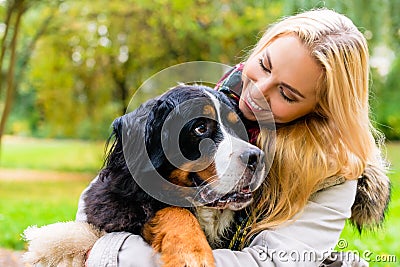 Woman embracing her dog in autumn park Stock Photo