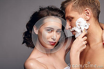 Woman embracing and shaving man Stock Photo