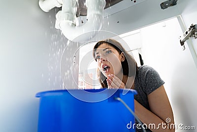 Woman With Emergency Plumbing Sink Leak Stock Photo