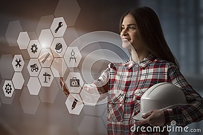 Woman engineer touching a virtual holograph display, using innovative technology to manage her work Stock Photo