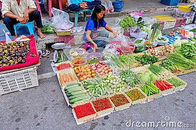 A woman is enjoy selling vegetables at Prachuabkirikhan morning market showing local lifestyle. Prachuabkirikhan Thailand June 10 Editorial Stock Photo