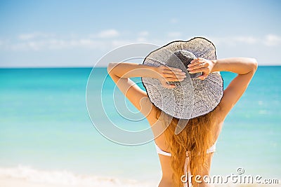 Woman enjoying beach relaxing joyful in summer by tropical blue water Stock Photo