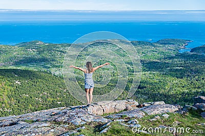 Woman enjoying the beautiful view of small islands seen from Cadillac mountain in Acadia National Park Maine USA Stock Photo