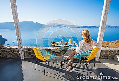 Woman enjoying breakfast with beautiful view from terrace Stock Photo