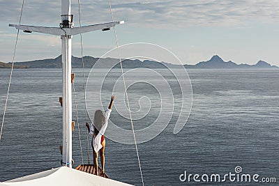 Woman enjoying cruise on luxury white yacht. Wealth and freedom travel concept Stock Photo