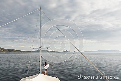 Woman enjoying cruise on luxury white yacht. Wealth and freedom travel concept Stock Photo