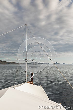 Woman enjoying cruise on luxury white yacht. Wealth and freedom travel concept Stock Photo