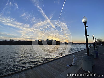 Woman Enjoying the Pretty Sunset at the Georgetown Waterfront in Winter Editorial Stock Photo