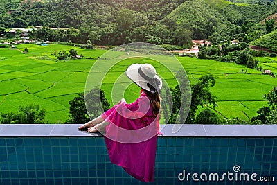 Woman enjoying rice terrace viewpoint and green forest in Nan, Thailand Stock Photo