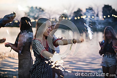 Woman Enjoying Sparkler in Festival Event Stock Photo