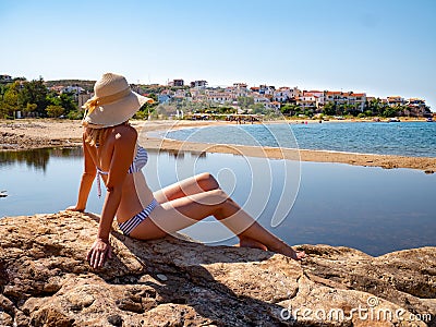 Woman enjoying the sun at the beach on Platanes Beach, Thasos Editorial Stock Photo
